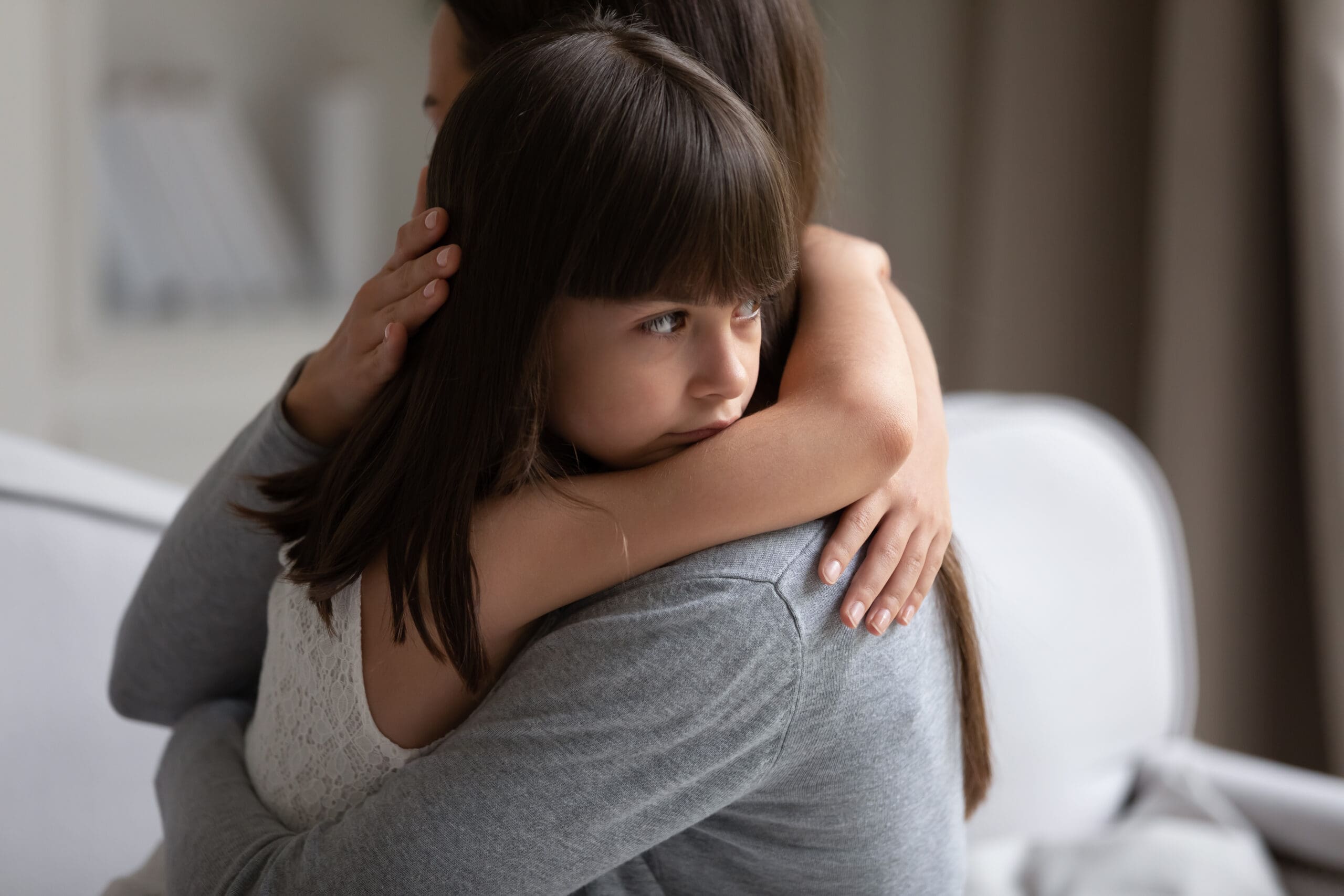 emotional child hugging mother